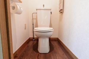 a white toilet in a bathroom with a wooden floor at Japandi 6 Inspired 1BR in Prime City Spot and Near Station in Fukuoka