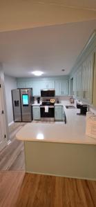 a large kitchen with a white counter top and appliances at Nexton Nest in Summerville