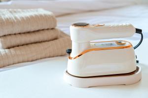 a hair dryer sitting on a table next to towels at Japandi 6 Inspired 1BR in Prime City Spot and Near Station in Fukuoka