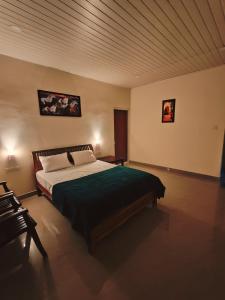 a bedroom with a large bed with a wooden ceiling at Aden Valley Resort in Kanthalloor