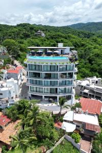 a building with a swimming pool on top of it at El Cielo Sayulita in Sayulita