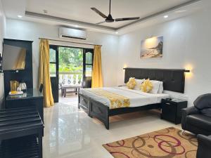 a bedroom with a bed and a living room at Silver Sands Sunshine - Angaara in Candolim +57 photos