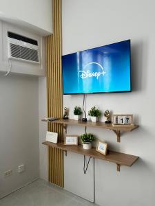 a living room with a tv on a wall at Casa Mira Mandaue unit 608 Tower 4 in Cebu City