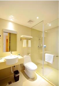 a bathroom with a toilet and a sink and a shower at City Comfort Inn Wuhan Wangjiawan Sixin Avenue Metro Station in Wuhan