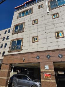 a car parked in front of a building at Yeoncho Money Stay in Geoje 