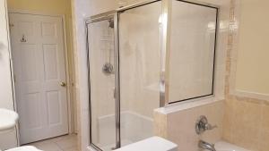 a bathroom with a shower with a sink and a toilet at Morningstar Shores in Union Pier +23 photos
