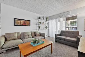 a living room with a couch and a table at Game Day Ready Steps to Big House, U-M Campus & UM Hospital in Ann Arbor