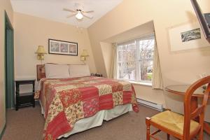a bedroom with a bed and a window at Gower Guest House in St. John's