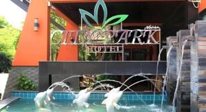 a group of white swans in a swimming pool at City Park Hotel in Phatthalung
