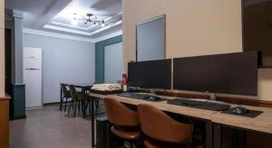 Zimmer mit einem Schreibtisch, einem Computer und Stühlen in der Unterkunft Hotel No.1 in Seryu-dong