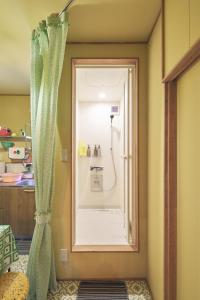 a bathroom with a shower with a shower curtain at Retoro MeIeki 1號室 in Nagoya