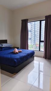 a bedroom with a bed and a large window at MZS Studio Swiss Garden R in Kuantan