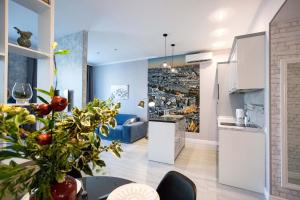 a kitchen and a living room with a table at Jane Stone Apartments in Odesa