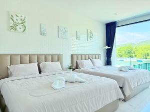 two beds sitting next to each other in a bedroom at The Ocean Pool Villa HuaHin in Hua Hin +63 photos