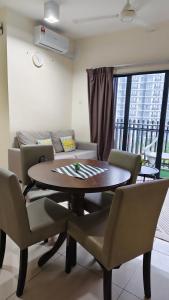 a living room with a table and chairs and a couch at MZS Studio Swiss Garden R in Kuantan