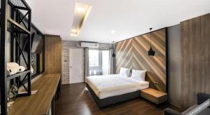 a bedroom with a bed and a wooden wall at The Circle Hotel in Ban Bu Lamduan +146 photos