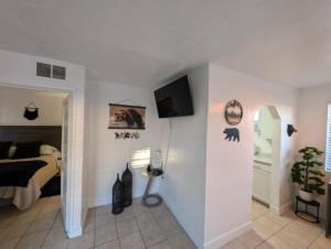 a bedroom with a bed and a tv on a wall at Bear cave in Tucson