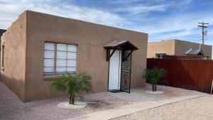 a house with a white door and a fence at Bear cave in Tucson