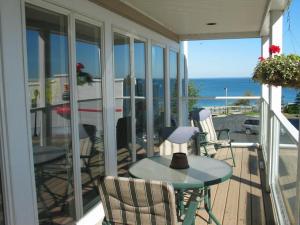 a balcony with a table and chairs and the ocean at Pier Harbor #2 in Saint Ignace +28 photos