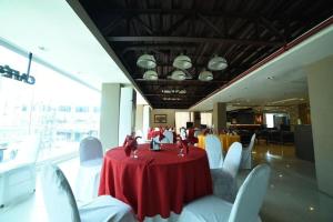 a room with a red table and white chairs at Marcian Business Hotel in Zamboanga