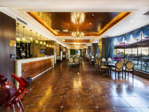 a lobby of a restaurant with chairs and tables at Metropolo Hotel Yining Development Zone Hanma Building in Yining Airport