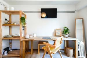 a room with a wooden desk and a shelf at Japandi 4 Inspired 1BR in Prime City Spot and Near Station in Fukuoka +44 photos