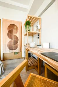 a room with a wooden desk and wooden shelves at Japandi 4 Inspired 1BR in Prime City Spot and Near Station in Fukuoka