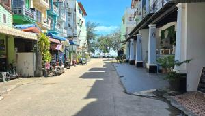 an empty street in a city with buildings at You And Me Guesthouse in Cha Am +21 photos
