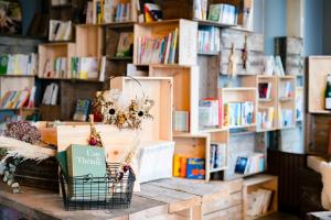 a book shelf with books on a table in a bookstore at The Book Lounge Hotel Kani in Kani