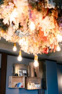 a bunch of lights hanging from a ceiling at The Book Lounge Hotel Kani in Kani