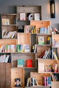 a bunch of books on shelves in a room at The Book Lounge Hotel Kani in Kani