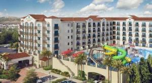 a large hotel with a water slide in front of it at Courtyard by Marriott Anaheim Theme Park Entrance in Anaheim