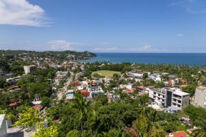 an aerial view of a city and the ocean at El Cielo Sayulita in Sayulita