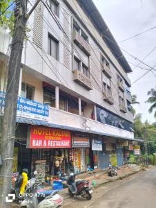 a building with motorcycles parked in front of it at Hotel Kalyani International in Mūlki +13 photos