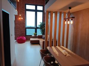 a room with a table and chairs and a couch at New York Style loft with computer gaming and bricks in Iskandar Puteri