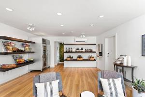 a living room with two chairs and a counter with wine bottles at UpValley Inn & Hot Springs, an Ascend Collection Hotel in Calistoga