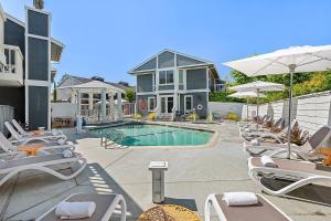 a swimming pool with lounge chairs and a house at UpValley Inn & Hot Springs, an Ascend Collection Hotel in Calistoga