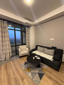 a living room with a couch and a table at Ines’s sweet home in Yerevan