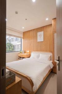 a bedroom with a large bed and a window at Minh Anh Apartment 2 in Thôn Văn Dương