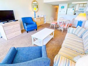a living room with a couch and a table at Verandas 602 in North Myrtle Beach