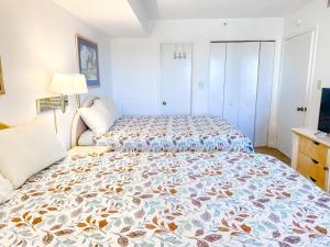 a bedroom with a large bed with a colorful bedspread at Verandas 602 in North Myrtle Beach +17 photos