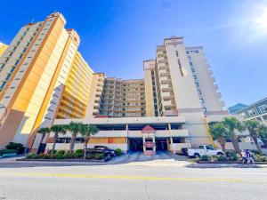 two tall buildings with palm trees in front of a building at Verandas 602 in North Myrtle Beach