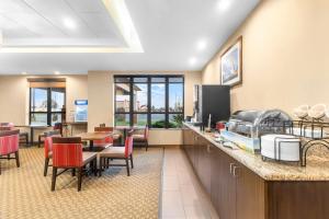 a lobby with a waiting area with tables and chairs at Comfort Inn & Suites Sikeston I-55 in Sikeston