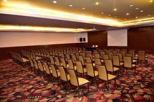 a conference room with chairs and a screen in it at LRH Calama, an Ascend Collection Hotel in Calama +71 photos
