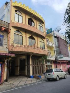 a car parked in front of a building at Hotel Bintang in Kisaran
