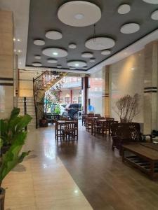 a restaurant with tables and chairs and a dining room at Hotel Bintang in Kisaran