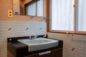 a bathroom with a sink and a window at rinne 2nd living Nasu Forest in Wada