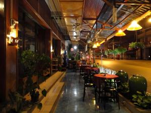 a row of tables and chairs in a restaurant at Panorama Hotel in Mae Hong Son