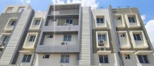 a tall white apartment building with a sky background at Collection O MKU Madurai Formerly Mpl Elite in Samayanallūr +11 photos