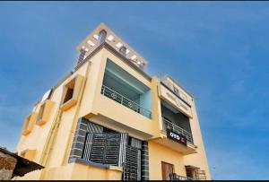 a tall building with balconies and a blue sky at Hotel O Palasuni Bridge Bhubaneswar Formerly Ganpat in Mancheshwar +8 photos